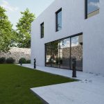 A contemporary white house with large windows and a spacious grass lawn.